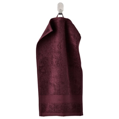 Dark maroon FREDRIKSJÖN cotton towel with ribbed edges hanging.