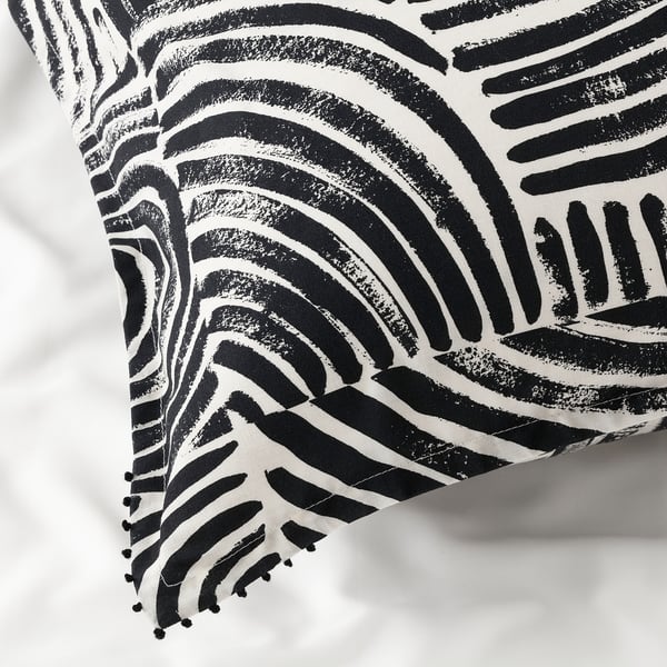 Black and white patterned pillowcase with intricate designs and fringe detail, showcasing high-quality cotton texture and craftsmanship.
