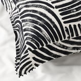 Black and white patterned pillowcase with intricate designs and fringe detail, showcasing high-quality cotton texture and craftsmanship.