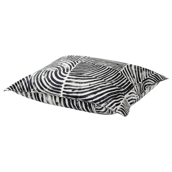 Black and white patterned pillow with wavy lines, square shape, and french knots at corners.