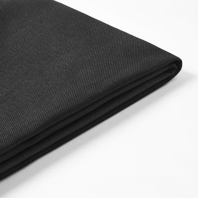 Close-up of high-quality black fabric from recycled materials, showing fine texture and neat sewing.
