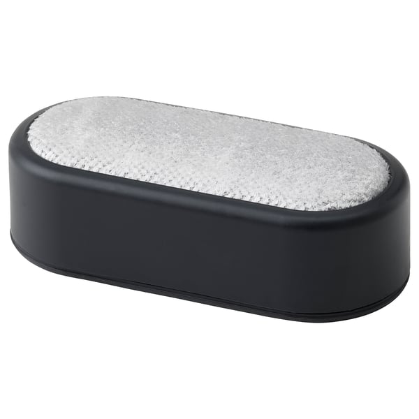 A black oval-shaped lint brush with a white fuzzy surface, designed to remove lint and hair from clothes.