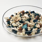 Clear bowl filled with mixed dried flowers and pine cones, showcasing high-quality, natural decor.