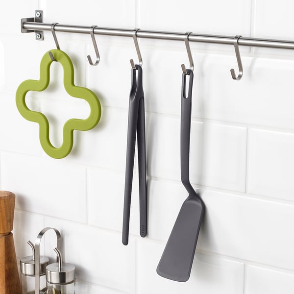 Anchor tools on wall hooks for easy kitchen access.