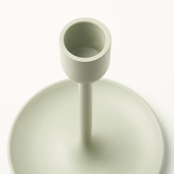 Light green candlestick with textured top, smooth body, and felt base, displayed against a white background.