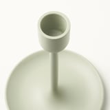 Light green candlestick with textured top, smooth body, and felt base, displayed against a white background.