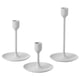 Option: Three white FULLTALIG candlesticks in varying heights, sleek minimalist design with aluminum and epoxy coating.