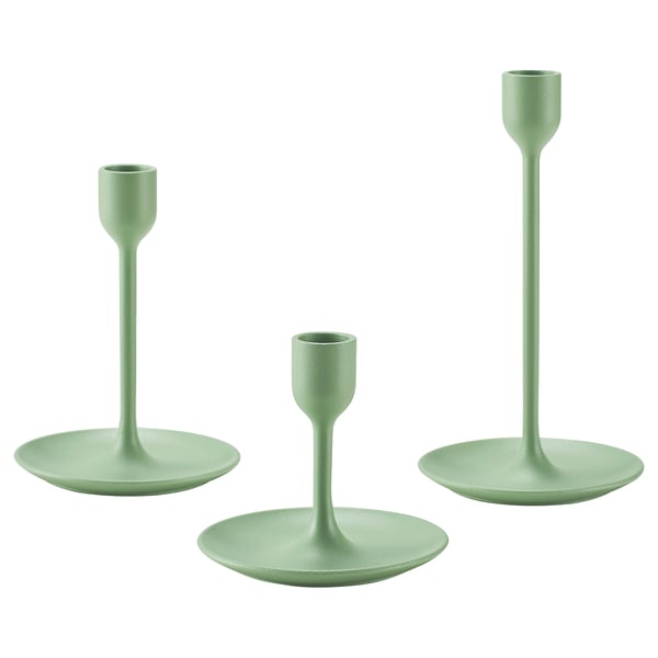 Three modern green candlesticks, varying in height, with sleek design and felt bases for stability.