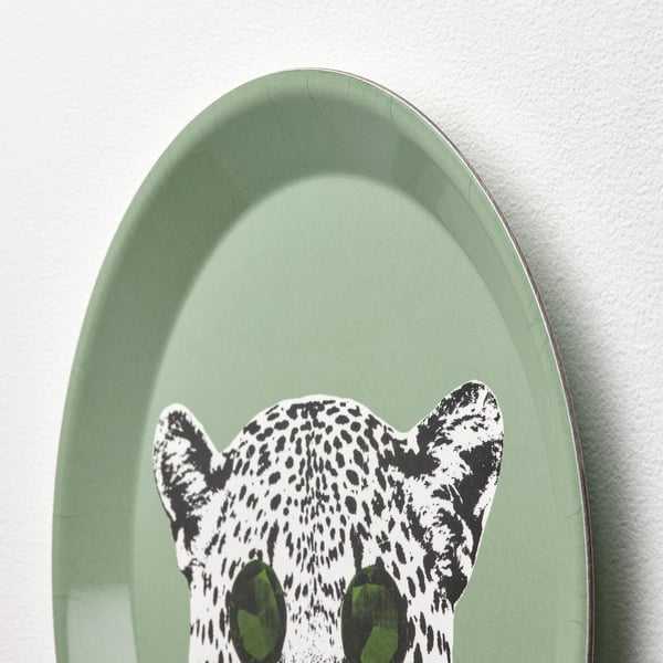 A stylish green oval wall decor featuring a playful white leopard with black spots and green eyes.
