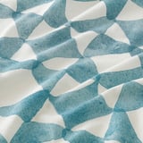 Geometric, hand-drawn curtain pattern. Blue shapes on natural fabric, elegant and textured.