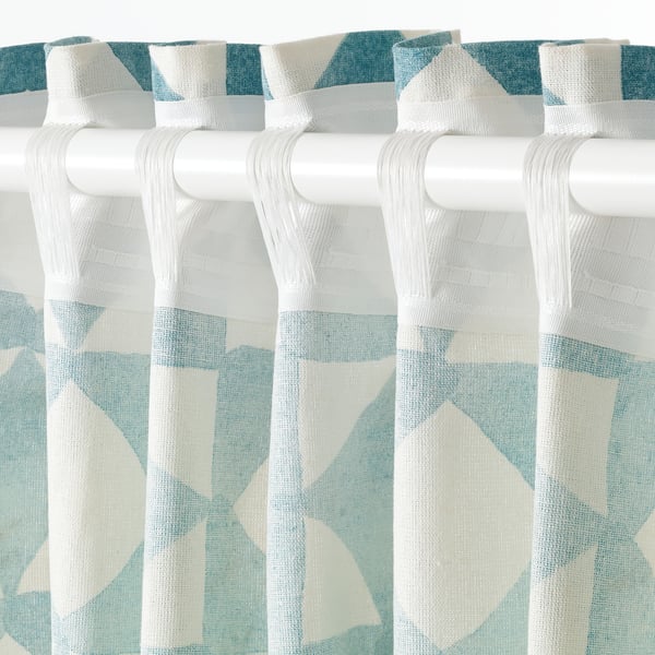 Geometric-patterned curtains hang from white rod, allowing light while providing privacy.