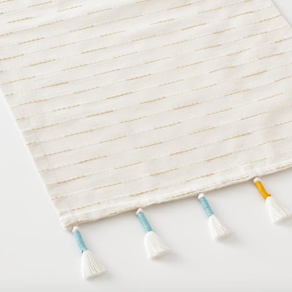 Handwoven cotton-blend table runner with multi-colored tassels.
