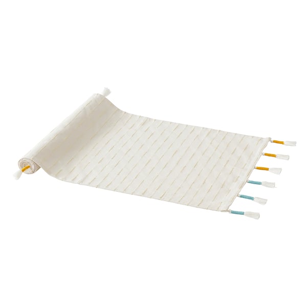 A gokvållå cream table runner with gold stripes, featuring handmade tassels in blue and orange. Made of cotton and polyester.