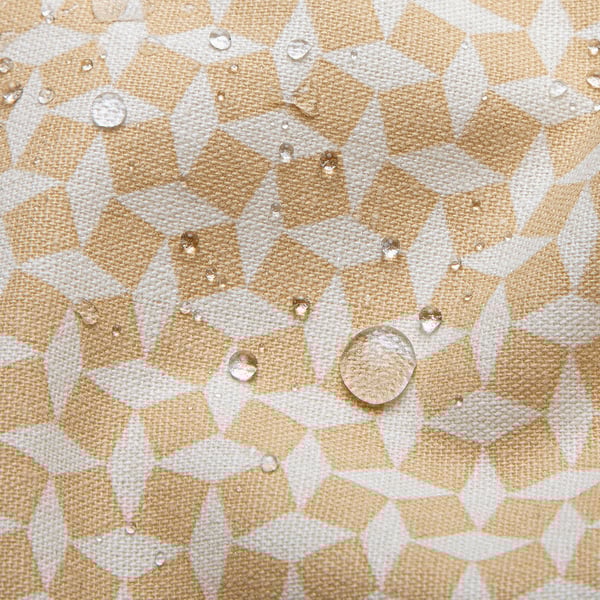 Water repellent beige and white diamond patterned tablecloth with water droplets, showcasing its protective and easy-to-clean feature.