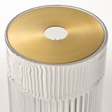 Clear glass vase with vertical grooves, golden metal lid, single flower stem holder.