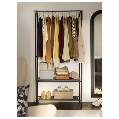 The black GRÅFJÄLLET clothes rack with an industrial design, combining metal frames and particleboard shelves.