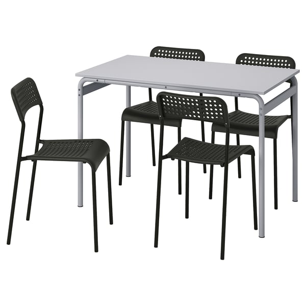 Black plastic chairs and gray metal table set. Modern, stackable design.