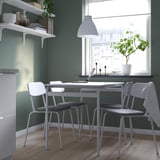 Modern home workspace with GRÅSALA chair, table, and green wall shelf. Laptop, plant, and metallic fabric chair.
