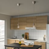 Modern hanging lamps over kitchen island.