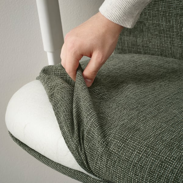 Image shows a hand adjusting an ergonomic office chairs seat depth for comfort.