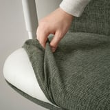 Image shows a hand adjusting an ergonomic office chairs seat depth for comfort.