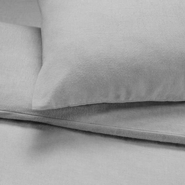 Gray cotton flannel bedding shown, softly folded. High-quality, smooth texture visible.