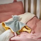 Soft grey cat toy on pale pink blanket; cozy, recycled material.