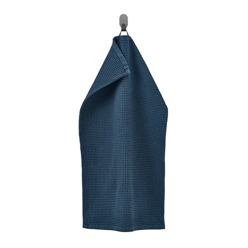Dark blue GULLDYNA recycled cotton towel hangs on hook.