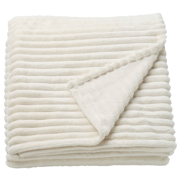 A folded GULLSTRÅLE blanket in white. Made from 100% recycled polyester, it a soft, textured stripe design.
