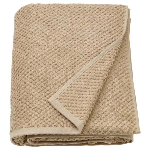 A beige GULVIAL towel, soft and fluffy, made of 100% cotton, rectangular shape, neatly folded.