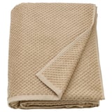 A beige GULVIAL towel, soft and fluffy, made of 100% cotton, rectangular shape, neatly folded.