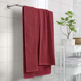 Burgundy towel GULVIAL hangs on wall, soft & fluffy, near plant.