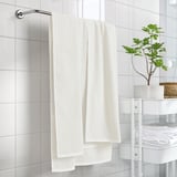 Beige towel on rack, larger than others.