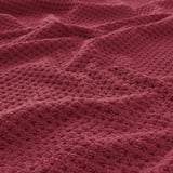 Close-up of soft, textured burgundy towel, showcasing its plush, fluffy weave.