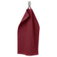 A burgundy GULVIAL towel hangs on a hook, textured, soft, and 100% cotton.