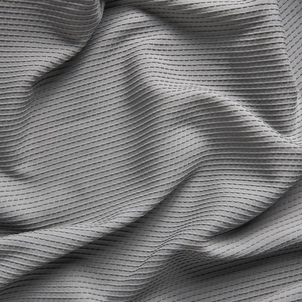 Textured, gray, draped curtain close-up, soft, woven pattern, light filtering, sound absorption material.