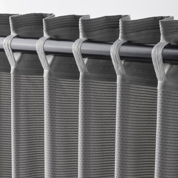 Blackout curtains with hooks, sound-absorbing, draped for privacy.