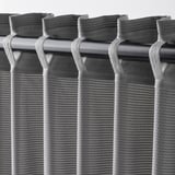 Blackout curtains with hooks, sound-absorbing, draped for privacy.