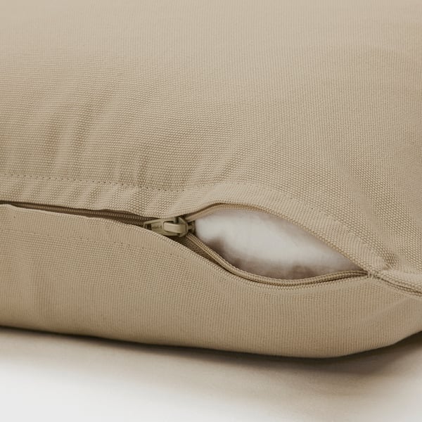 Close-up of tan GURLI cushion with hidden zipper for easy removal. Made of durable cotton for comfort.