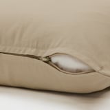 Close-up of tan GURLI cushion with hidden zipper for easy removal. Made of durable cotton for comfort.