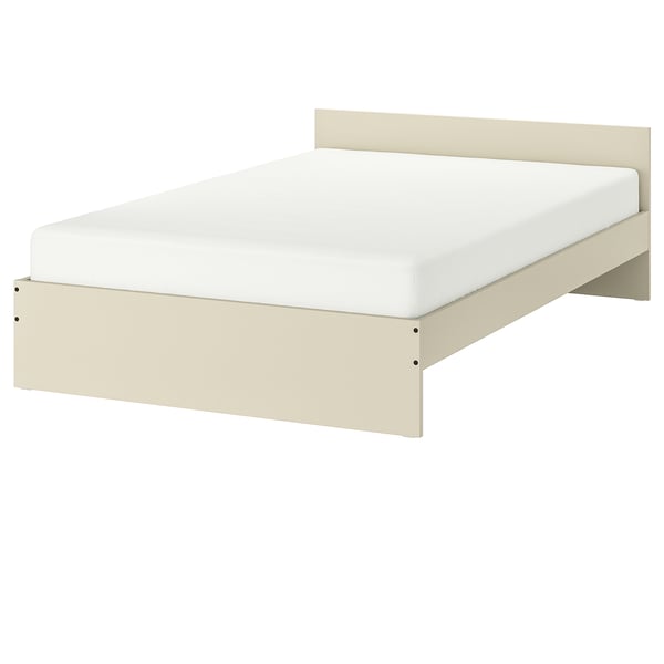 A GURSKEN bed in beige, featuring a simple, clean design with a white mattress.