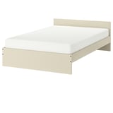 A GURSKEN bed in beige, featuring a simple, clean design with a white mattress.
