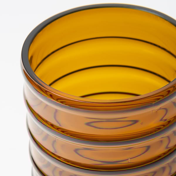 Stacked amber glass vases, showcasing craftsmanship and recycled texture.