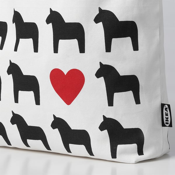 A fabric bag with black horse and red heart prints, highlighting its quality and design.