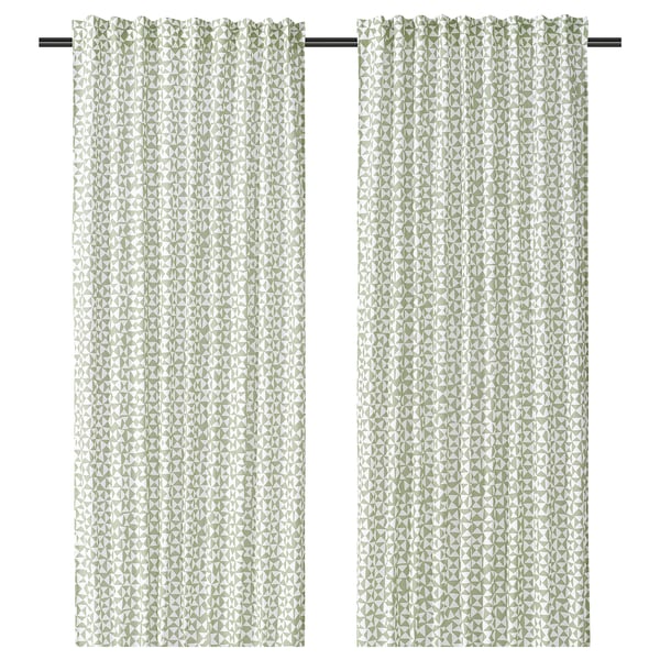 Pair of patterned green-white curtains with triangular design.