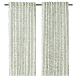 Pair of patterned green-white curtains with triangular design.
