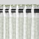 Green-white triangle pattern curtains with pleated heading for privacy and light filtering.