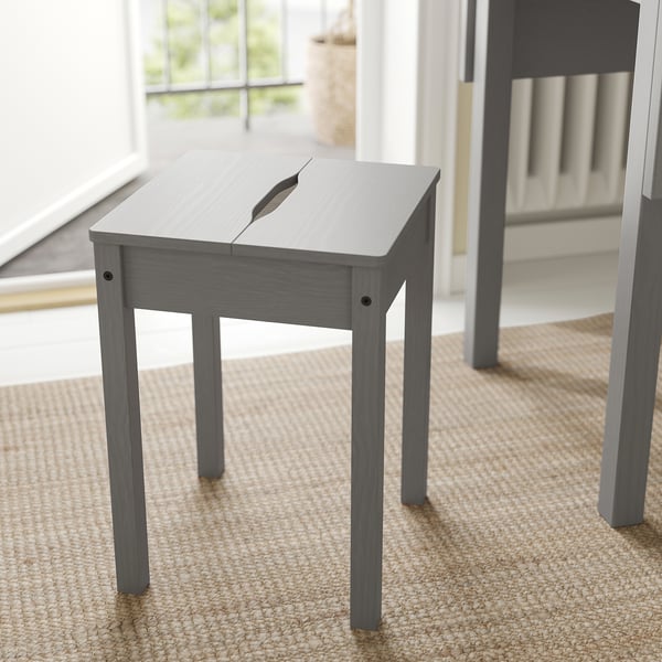 Modern gray HAUGA drop-leaf table with wooden legs fits compact spaces, ideal for small kitchens or dining areas.