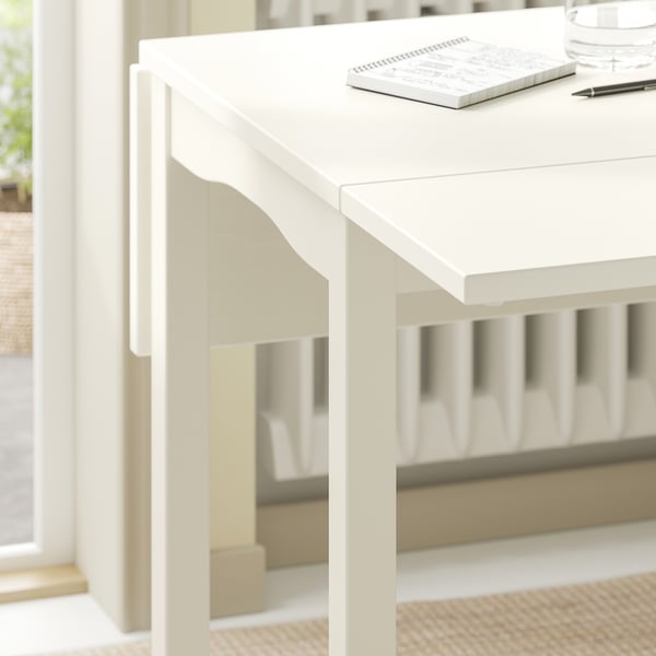 A white HAUGA drop-leaf table with clean lines and a flat top, perfect for compact spaces.