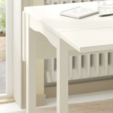 A white HAUGA drop-leaf table with clean lines and a flat top, perfect for compact spaces.
